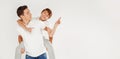 Photo of young happy boys, brothers, playing and smiling together on the light gray studio background Royalty Free Stock Photo