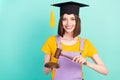 Photo of young happy charming woman hold hands hammer judge graduate isolated on pastel teal color background