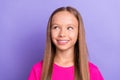 Photo of young happy cheerful dreamy small girl look empty space imagine good mood isolated on violet color background