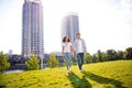 Photo of young happy couple partners soulmates lovers hands together walking around together outdoors spend summer time Royalty Free Stock Photo