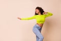 Photo of young happy funny lady wear yellow top dancing balet studio looking empty space isolated on beige color