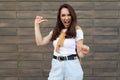 Photo of young happy joyful attractive brunette woman with sincere emotions wearing stylish outfit standing in the