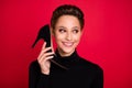 Photo of young happy positive funky woman look empty space hold shoe talk call isolated on red color background