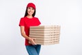 Photo of young happy smiling cheerful service girl delivery stack of pizza fast food on grey color background