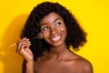 Photo of young happy smiling lovely dreamy african girl look copyspace apply highlighter on yellow color