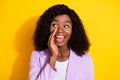 Photo of young happy tricky afro businesswoman look copyspace tell gossip rumor isolated on yellow color background
