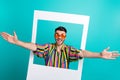 Photo of young hipster funky man wait hugs from his friends inside paper frame wear sunglasses rayban isolated on
