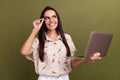 Photo of young hispanic office manager girl working with laptop touching specs looking curious copyspace isolated on Royalty Free Stock Photo