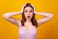 Photo of young impressed woman arms touch head shock surprised isolated over yellow color background