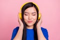 Photo of young joyful calm pretty woman listen music headphones good mood isolated on pink color background Royalty Free Stock Photo