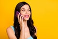 Photo of young lady hold telephone look empty space talk listen wear blue top isolated yellow color background