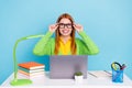 Photo of young lady work from home hands spectacles wear green sweater isolated on blue color background
