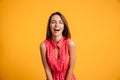 Photo of young laughing pretty brunette woman in red dress