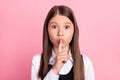 Photo of young little girl cover lips finger shh keep secret confidential shut up isolated over pink color background