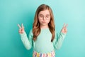 Photo of young little girl dreamy plump lips show peace cool v-sign isolated over teal color background