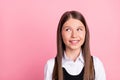 Photo of young little girl happy positive smile curious wonder look empty space isolated over pink color background