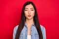 Photo of young lovely asian girl pouted lips send air kiss love feelings valentine day isolated over red color