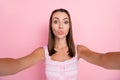 Photo of young lovely lady pouted lips send air kiss flirty make selfie isolated over pink color background