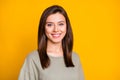 Photo of young lovely pretty good mood smiling cheerful happy girl with silky brown hair isolated on yellow color