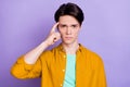 Photo of young man finger touch head accuse stupid blame think isolated over violet color background