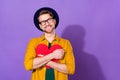 Photo of young man happy positive smile hug heart dream love feelings look empty space isolated over violet color