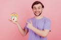 Photo of young man happy positive smile point finger clock alarm late isolated over pastel color background