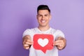 Photo of young man happy positive smile show heart like icon blogger click advise advert isolated over purple color