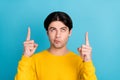 Photo of young man look indicate finger empty space advertise advise choose direct way recommend isolated over blue Royalty Free Stock Photo