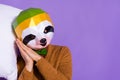 Photo of young man sleepy enjoy dreamy sleepover weird red panda isolated over purple color background