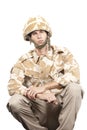Portrait of young military soldier sitting in uniform