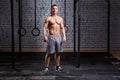 Photo of a young muscular crossfit sportsman while standing against brick wall. Royalty Free Stock Photo
