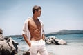 Attractive man of model appearance posing on tropical beach Royalty Free Stock Photo
