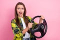 Photo of young nervous girl driving first time accident wear yellow checkered shirt hold steering wheel confused