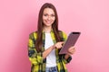 Photo of young office manager assistant girl wear yellow checkered jacket hold tablet browsing internet check tasks Royalty Free Stock Photo