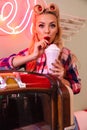 Photo of young pleased woman drinking milkshake while leaning jukebox