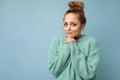 Photo of young positive beautiful blonde woman with sincere emotions wearing casual blue pullover isolated over blue Royalty Free Stock Photo