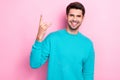 Photo of young positive cheerful handsome guy smiling enjoy his rock roll music album showing horned symbol fingers Royalty Free Stock Photo