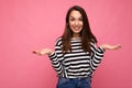 Photo of young positive happy beautiful brunette woman with sincere emotions wearing casual striped pullover isolated on Royalty Free Stock Photo