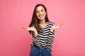 Photo of young positive happy beautiful brunette woman with sincere emotions wearing casual striped pullover isolated on Royalty Free Stock Photo