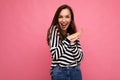 Photo of young positive happy emotional beautiful brunette woman with sincere emotions wearing casual striped pullover Royalty Free Stock Photo