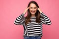 Photo of young positive happy smiling beautiful brunette woman with sincere emotions wearing casual striped pullover Royalty Free Stock Photo