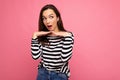 Photo of young positive happy surprised astonished beautiful brunette woman with sincere emotions wearing casual striped Royalty Free Stock Photo