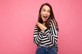 Photo of young positive happy surprised beautiful brunette woman with sincere emotions wearing casual striped pullover Royalty Free Stock Photo