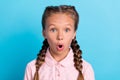 Photo of young preteen girl amazed shocked surprised stupor omg wow isolated over blue color background Royalty Free Stock Photo