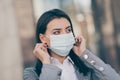 Photo of young pretty businesswoman wear adjust medical mask quarantine job worker outside in outdoors