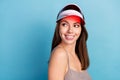 Photo of young pretty charming woman look empty space wear tennis hat smile isolated on blue color background