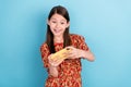 Photo of young pretty girl have fun play game cellphone free-time isolated over blue color background