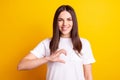 Photo of young pretty girl show fingers half of heart cupid feelings isolated over yellow color background