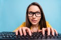 Photo of young pretty woman bite lips teeth worried nervous typing keyboard computer isolated over blue color background