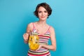 Photo of young satisfied girl summertime holding jug glass orange juice lemonade drinking fresh beverage isolated on